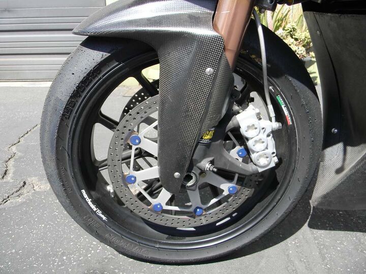 Fork tubes feature internals from Traxxion Dynamics, while Swedish firm ISR provides the six-piston brake calipers. Dunlop provides tires for the entire Moto2 category, and in this application they sit on forged magnesium Marchesini wheels.