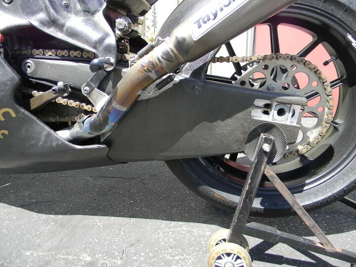 Testing revealed the original carbon swingarm would flex torsionally under load, causing massive front chatter. This, the fifth iteration of the swingarm, features a substantial cross-section of material in order to spread the torsional load over a large surface.