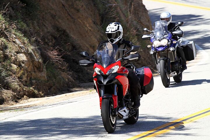 Two adventure touring bikes exiting a corner