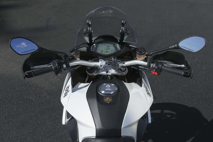 The view from the rider’s seat presents a healthy 6.3-gallon fuel tank with a narrow seat junction. You’re also greeted by very wide bars, an easily-viewable dash and manual windscreen. Look closely and you can also see the awkwardly placed cruise control button at the top of the right switchgear.