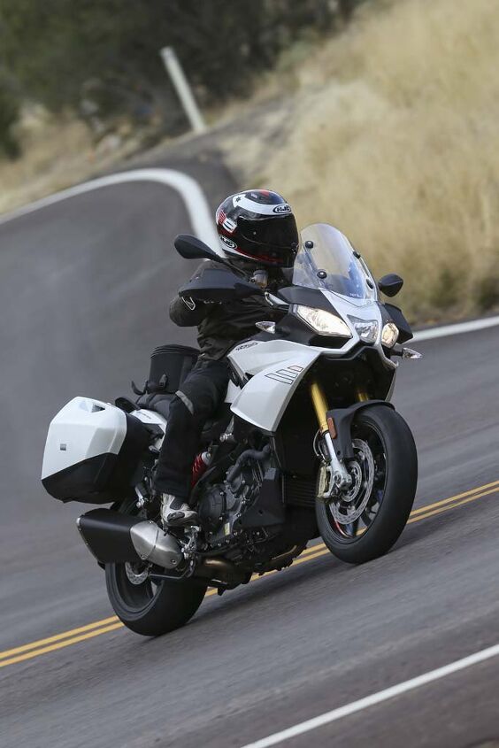 Wide bars on the Caponord help throw the 599-lb (fully fueled) motorcycle into turns. I had no ground clearance issues, but a heavier, more aggressive rider said he dragged hard parts. Note the hand guards, which lend to the A-T personality.