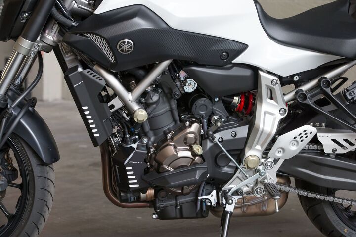 Any discussion about the FZ-07 has to start with its price. From there, its engine is the star of the show. The 689cc parallel-Twin is all-new and full of character. Look carefully and you can even see the throttle cables. Note also the easily accessible oil filter and drain plug located at the front of the engine.