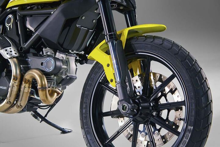 A single front disc brake shows off the right side of wheels unique to the Scrambler.