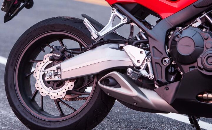 Details like the stylized steel frame and aluminum swingarm (the only one of the group) are nice touches on the Honda, as is the clever exhaust cover hiding what would otherwise be an exposed (and ugly) exhaust canister.
