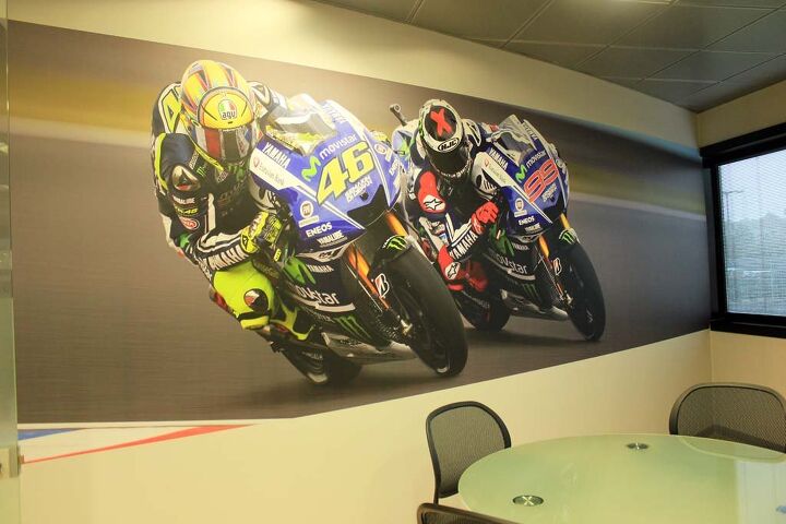 Wall art. Jarvis tells us that Rossi is super analytical with his bike’s setup. William Favero, Communications Manager of Yamaha Motor Racing, says VR46 would spend all day in the garage with his engineers and mechanics if he could. Jarvis believes Lorenzo has been less analytical in the past but is delving deeper into that aspect to make sure he is doing everything he can to remain competitive. Lorenzo’s skills are so high, according to Favero, that he “could ride a washing machine fast.”