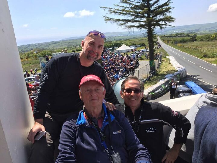 The author, Capone, with TT traveling buds John Santapietro from New Jersey, and Peter Thompson from Wales, take in the race action from the balcony of the famous Creg ny Baa.