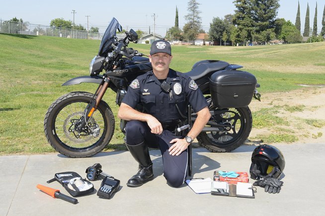 Lieutenant Chris Perry displays all of the equipment carried on the department’s Zeros. They include an electric flare, a first-aid kit, a Lidar speed gun, an electronic ticket “book,” disposable gloves and two clipboards for note-taking. The only extra piece of hardware carried on the V-Twins is a folding HK .223-caliber rifle.