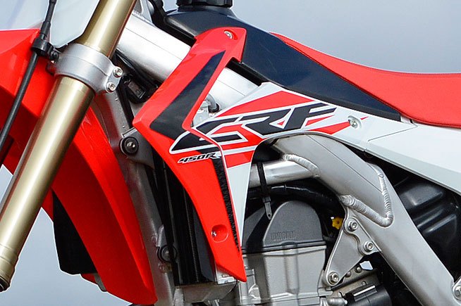 We’re not fans of the CRF’s angular radiator shrouds, which tend to snag knee guards and boot tops during hard cornering. The shrouds spoil an otherwise very good overall ergonomic package.