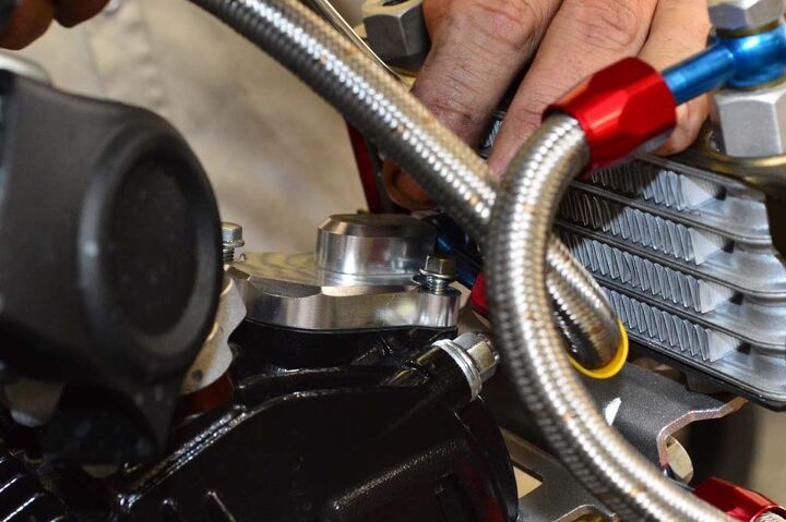 The supplied billet valve cover simply bolts into place using the supplied hardware. Clearance between the radiator and AN fitting can be a little tight for a box-end wrench. Less of an issue with an open end. 