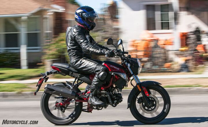 The Kymco K-Pipe is in its happy place jaunting around town with a newer rider in the saddle. Leathers optional.