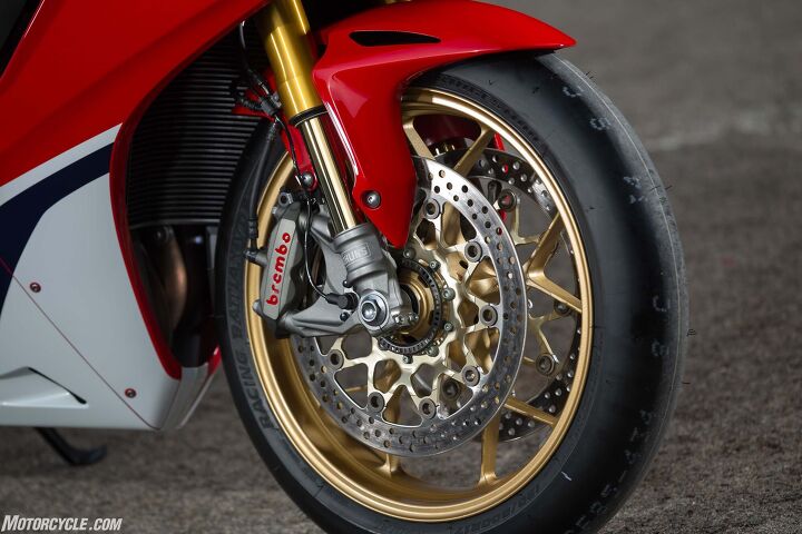 SP models get the upgraded Ohlins S-EC suspension and Brembo caliper over the standard bike’s Showa BPF and Tokico caliper. Wheels are the same cast units between the two, except standard gets black, SP gold. Forged wheels are saved for the limited-edition, SP2 race homologation version. Note also the Bridgestone V02 slick tire seen here. Pay no attention to it as the SP will be sold with B-Stone’s RS10 tire instead.