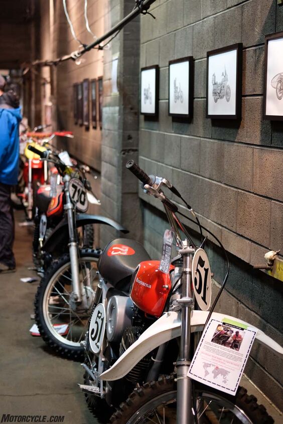 Vintage race bikes line an upstairs wall beneath art by Carter Asmann.