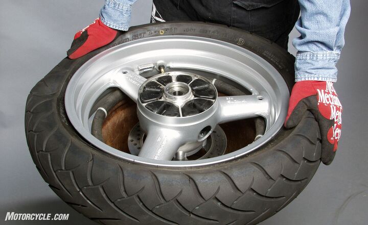 Working your way around the tire, press the bead into the center depression in the wheel. Flip the wheel and repeat.
