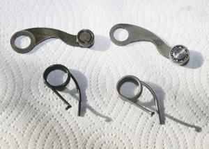 The Factory Pro Shift Kit (right) with its roller-bearing shift arm and stronger spring, compared to the OEM parts (left).