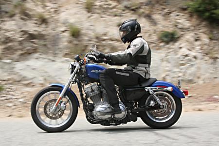 The H-D readily drags its exhaust on right-handed turns.