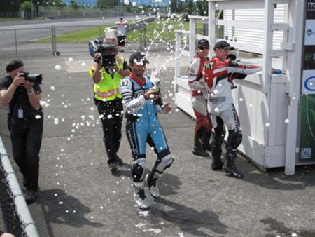 Racing Electric Motorcycles Champagne Celebration