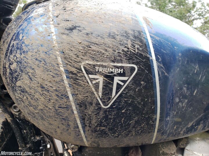 Mud-splattered Triumph Scrambler 1200 XE fuel tank