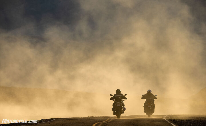 motorcycles in a cloud of dust