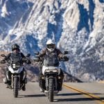 motorcycles in front of mountains