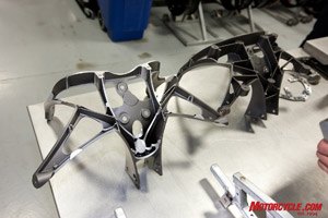 Lightweight magnesium is employed for the 1125R's upper fairing bracket. On the left is a lightened version used on Buell's racebikes.