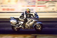 Hackfu, on board the FJR at the drag strip, on his way to a corrected 11.2 second E.T. at 118.8 mph. Tank bag included. 
