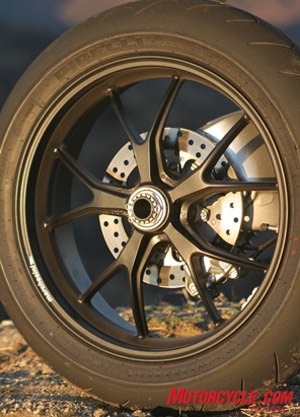 The artistic Marchesini rear wheel is exposed on the right side thanks to the single-sided swingarm. In between is a cleverly packaged 245mm brake rotor and two-piston caliper.